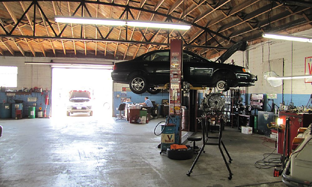 Inside the shop with a vehicle on the lift